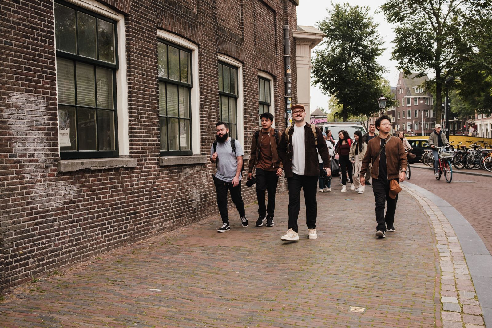 A diverse group walking an Amsterdam side street together