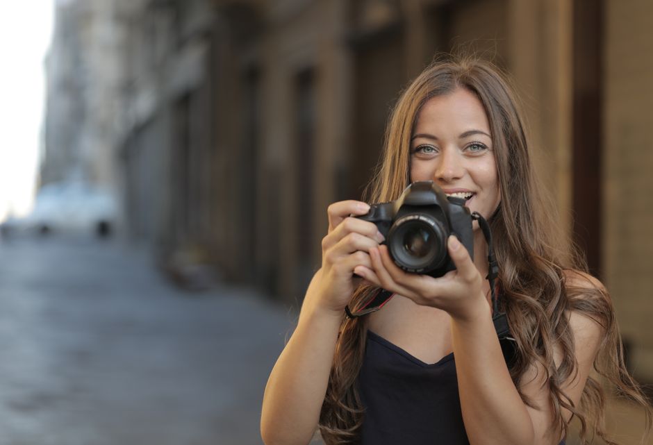 A woman with a camera on a city street