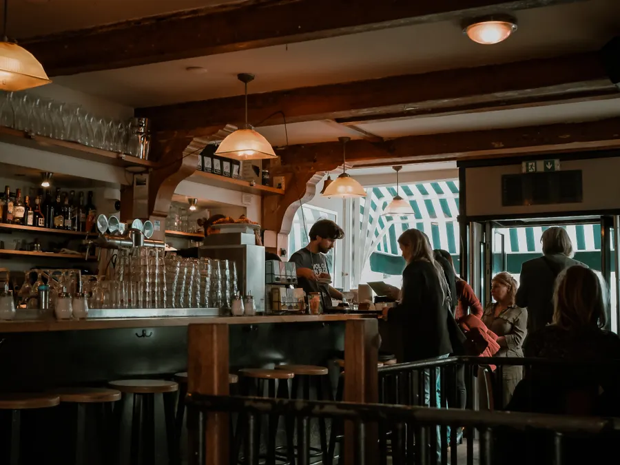 The inside of an Amsterdam brown cafe, with beer taps