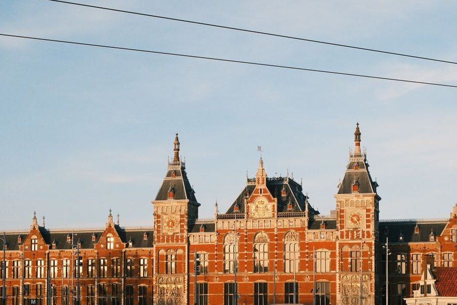 The front of Amsterdam Centraal station, seen across the water