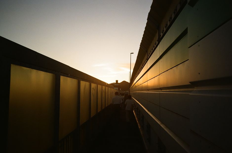 Long shadows down a city alley at sunset
