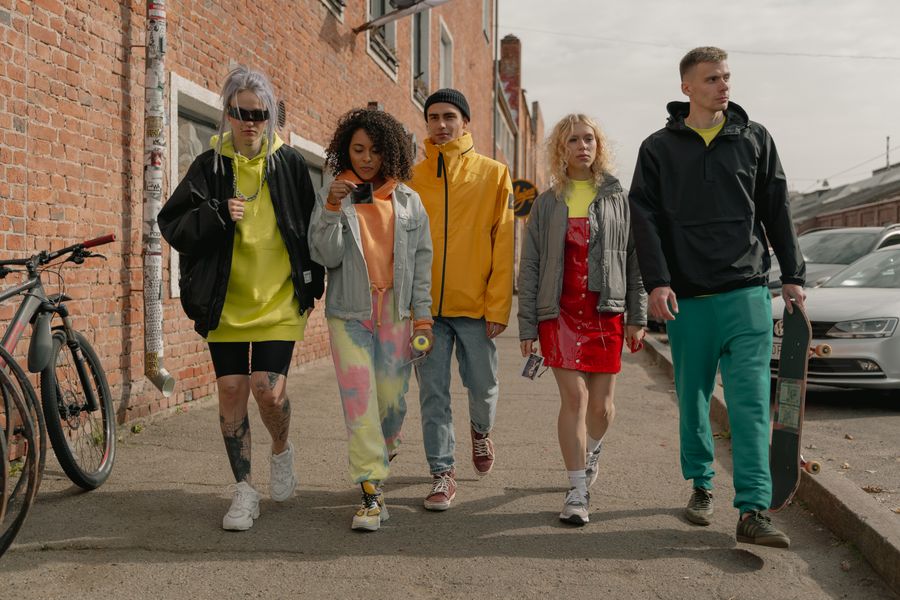 A group of friends walking together along a city street
